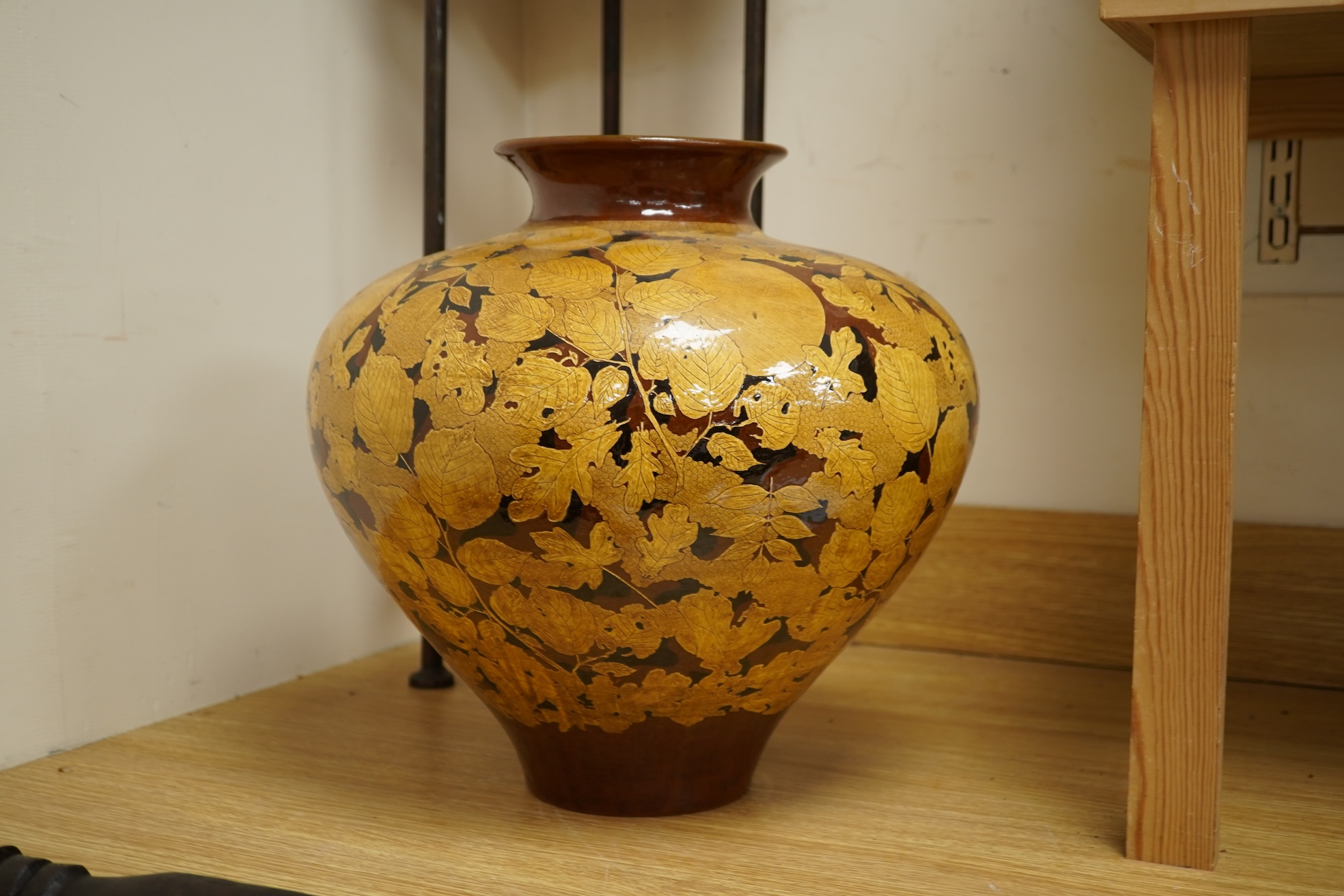 A large terracotta foliaiate decorated vase, 38cm high